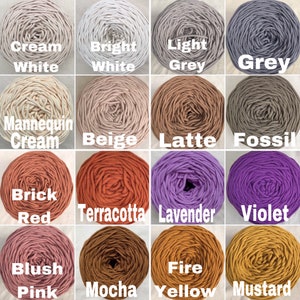 May include: A grid of sixteen circular skeins of cord yarn in various colors, each labeled with text including Cream White, Bright White, Light Grey, Grey, Mannequin Cream, Beige, Latte, Fossil, Brick Red, Terracotta, Lavender, Violet, Blush Pink, Mocha, Fire Yellow, and Mustard.