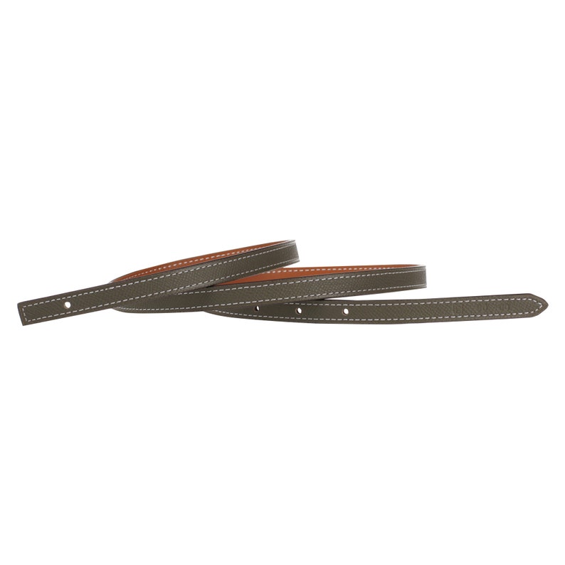 May include: A brown leather belt with a light brown underside and white stitching. The belt is folded in half.