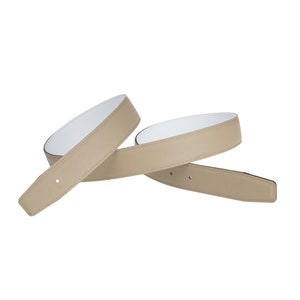May include: A beige leather belt with a white underside. The belt is folded in half and the ends are overlapping.