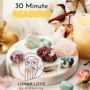 May include: A white marble plate with various crystals and stones, including amethyst, rose quartz, and agate. The plate is surrounded by cotton and a lit candle. The text "30 Minute Reading" and "LUNAR LOVE By Kimberley" is visible on the plate.