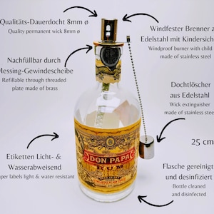 May include: A clear glass bottle with a gold label that reads "Don Papa Rum". The bottle has a metal cap with a childproof lock and a wick extinguisher. The bottle is 25 cm tall and is refillable through a threaded brass plate. The bottle is cleaned and disinfected.
