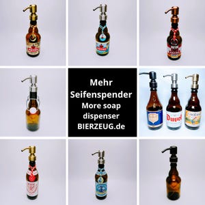 May include: A collection of glass soap dispensers shaped like beer bottles. The dispensers are decorated with various beer labels, including Astra, Duvel, and Chouffe. The dispensers are all in different colours, including brown, green, and blue. The text "Mehr Seifenspender More soap dispenser BIERZEUG.de" is displayed in the centre of the image.