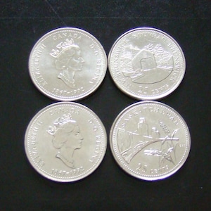May include: Four Canadian quarter coins. Two coins feature a profile of Queen Elizabeth II and the text "CANADA D.G. REGINA 1987-1992". The other two coins display provincial imagery and the text "25 CENTS".