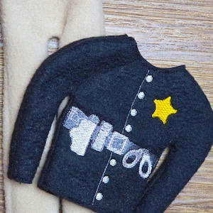 May include: A felt police officer costume, including a navy blue jacket with a yellow star and white embroidered details, and beige pants. The jacket features a belt and buttons. Perfect for imaginative play.