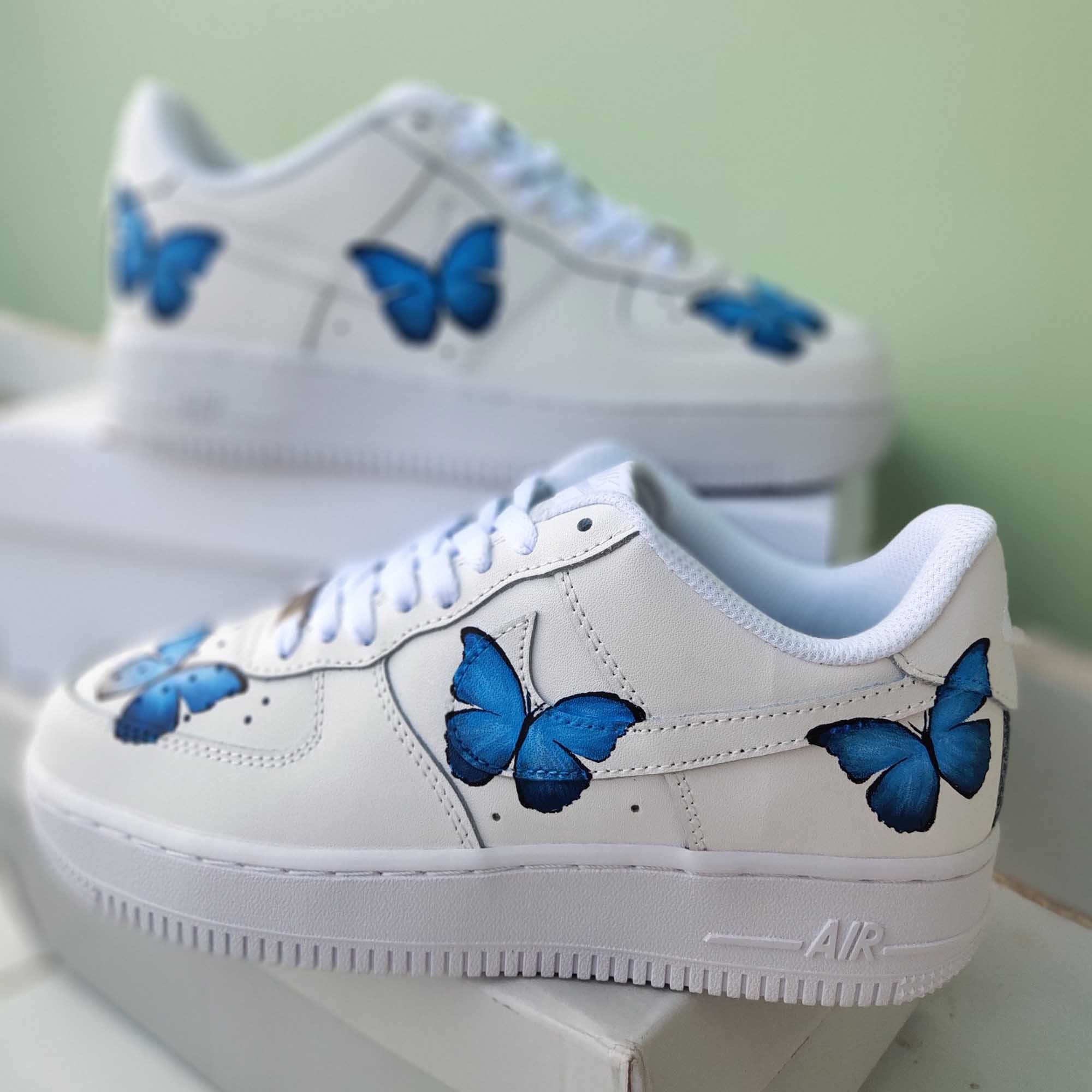white shoes with blue butterflies