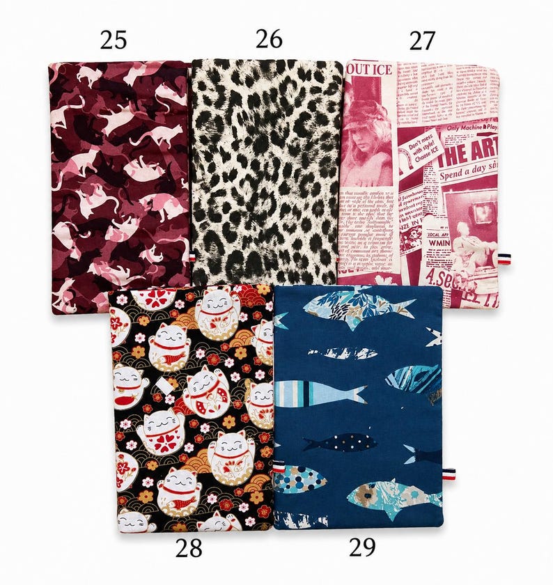 May include: Five rectangular fabric pouches labeled 25 through 29. Number 25 has a maroon cat pattern, 26 features a black and white leopard print, 27 displays a red and white newspaper collage, 28 shows black lucky cats, and 29 has blue fish.