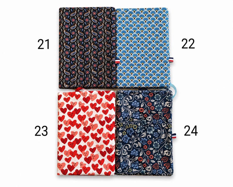 May include: Four rectangular fabric covers labeled 21 through 24. Number 21 has a black paisley print. Number 22 features a blue and white fan pattern. Number 23 displays red and pink heart faces on white. Number 24 shows a dark blue floral print.
