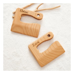 May include: Two wooden cutting boards with handles, personalized with the names "Eloise" and "Luca".