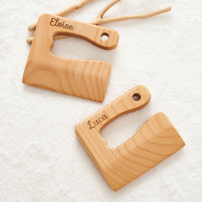 May include: Two wooden cutting boards with handles, personalized with the names "Eloise" and "Luca".