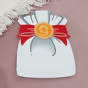 May include: A white paper bag with a red ribbon and a gold coin. The bag is decorated with a simple drawing of a bow.