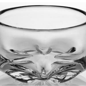 May include: A clear glass bowl with a wavy, textured design. The bowl is round and has a wide opening.