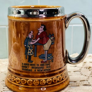 Lord Nelson Pottery Tankard Stein with Cartoon and Phrases A Good Wife Doesn't Begrudge Her Husband Heaven or Near Enough Funny Pint Mug