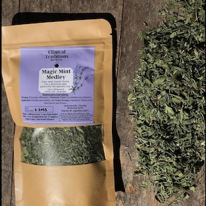 May include: A brown paper bag with a label that reads "Clinical Traditions Herb Co. Magic Mint Medley". The label lists the ingredients: Hyssop, Mountain Mint, Applemint, and Anise Hyssop. The bag contains a blend of dried herbs. The date harvested is 6-2023. The label also includes the address of the farm and apothecary: Jacksonville, Florida. The label states that the product has not been evaluated by the Food and Drug Administration and is not intended to diagnose, treat, cure, or prevent any disease.