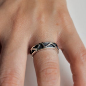 Fine artisan ring, made of sterling silver, with patinated low relief, model MUGA