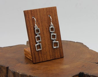 Handmade sterling silver earring with square shapes on a patinated background from the VOLARE series