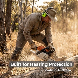 May include: A person wearing a hat and ear protection uses a chainsaw to cut a log. The chainsaw is orange and silver. The text "Built for Hearing Protection" and "Made in Australia" are visible.