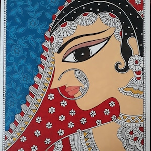 May include: An Indian-style painting of a woman in profile, wearing a red veil with white floral accents. The artwork features intricate details, including a nose ring and ornate jewelry. The background is blue with a floral pattern. The text "Anuja's Paintings" is visible.