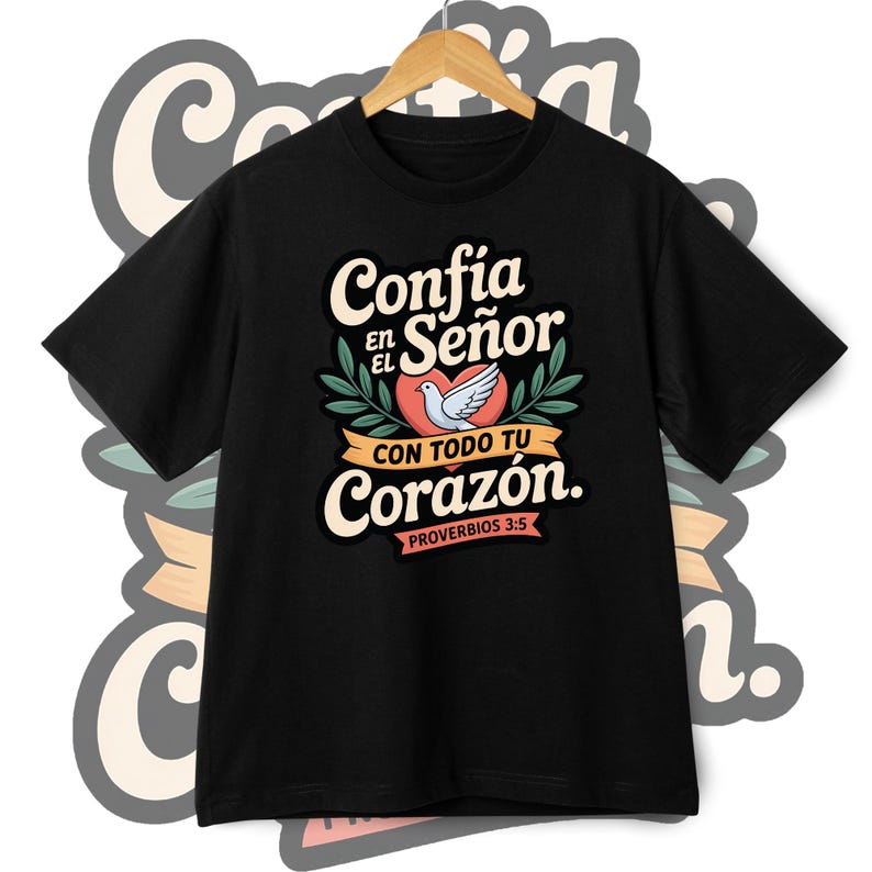 May include: Black t-shirt with a graphic design featuring the words "Conf&iacute;a en el Se&ntilde;or con todo tu coraz&oacute;n" in white and cream lettering, a red heart, and a white dove. The text "Proverbios 3:5" is also included.