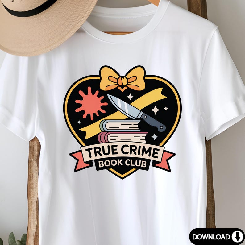 May include: White t-shirt featuring a graphic design with a black heart, a knife, books, and the text "TRUE CRIME BOOK CLUB". The design includes a yellow bow and a red sunburst.