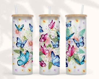 May include: Three white tumblers with a wood lid and a straw. Each tumbler features a different watercolour butterfly design with pink, blue, and purple butterflies on a white background with gold glitter.
