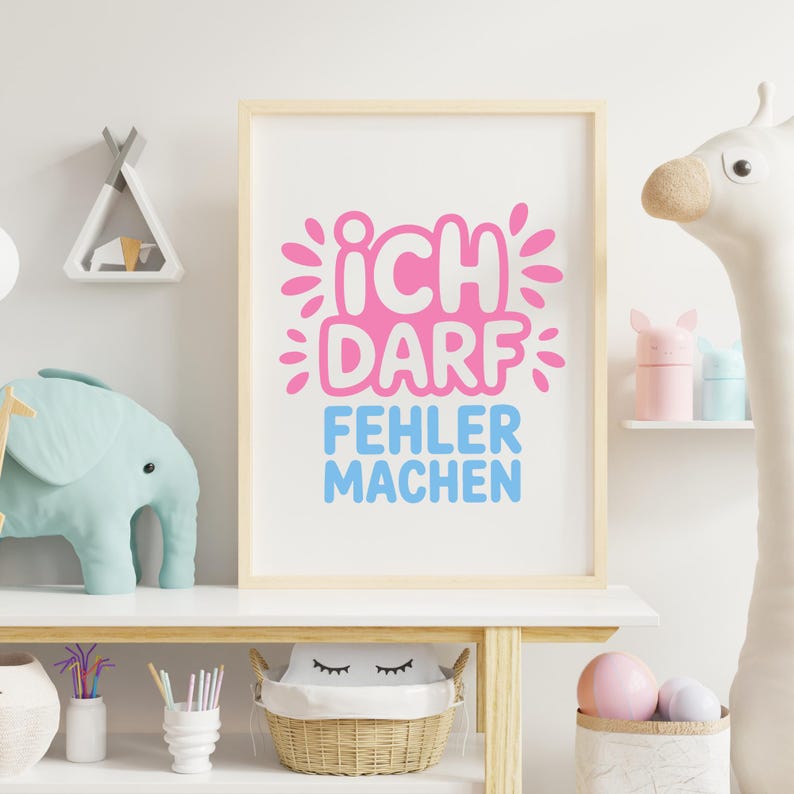May include: A framed print with the German text "ICH DARF FEHLER MACHEN" in pink and blue. The artwork is displayed on a white shelf with decorative items, including a stuffed elephant and a giraffe.
