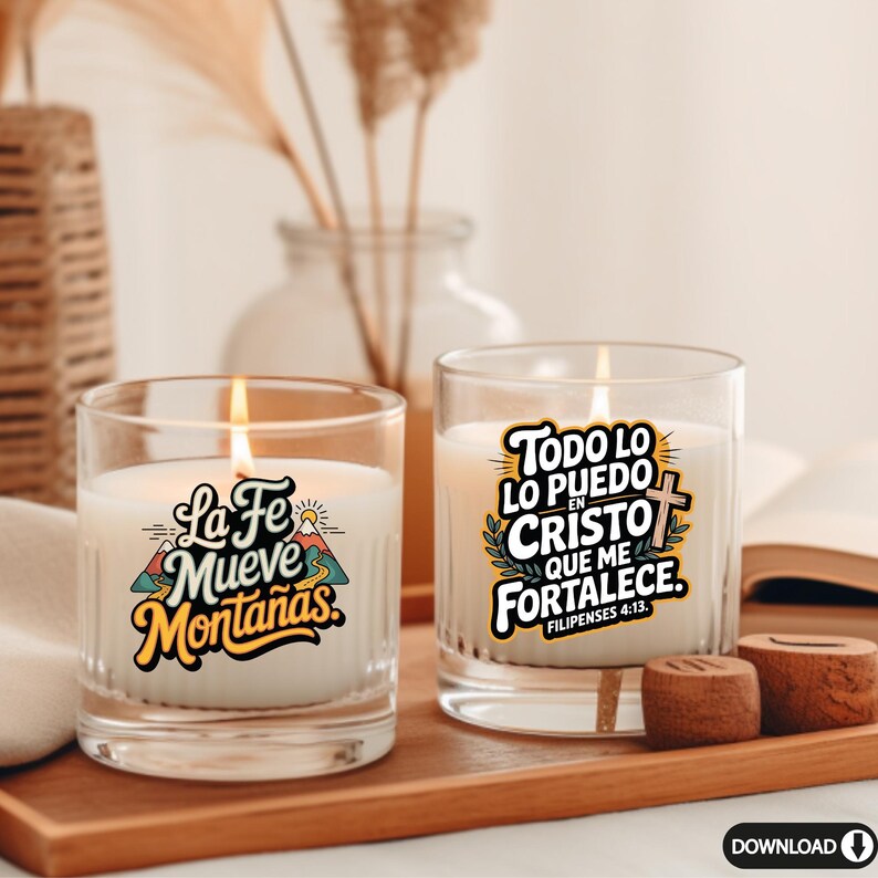 May include: Two lit glass candles with inspirational text. One candle reads "La Fe Mueve Monta&ntilde;as" with a mountain graphic. The other candle says "Todo lo puedo en Cristo que me fortalece" with a cross. Both candles sit on a wooden tray.