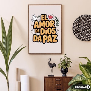 May include: A framed print with the text "EL AMOR DE DIOS DA PAZ" in yellow and black, featuring a dove, heart, and leaves. The artwork is displayed on a beige wall, complemented by a wooden cabinet, decorative items, and plants.