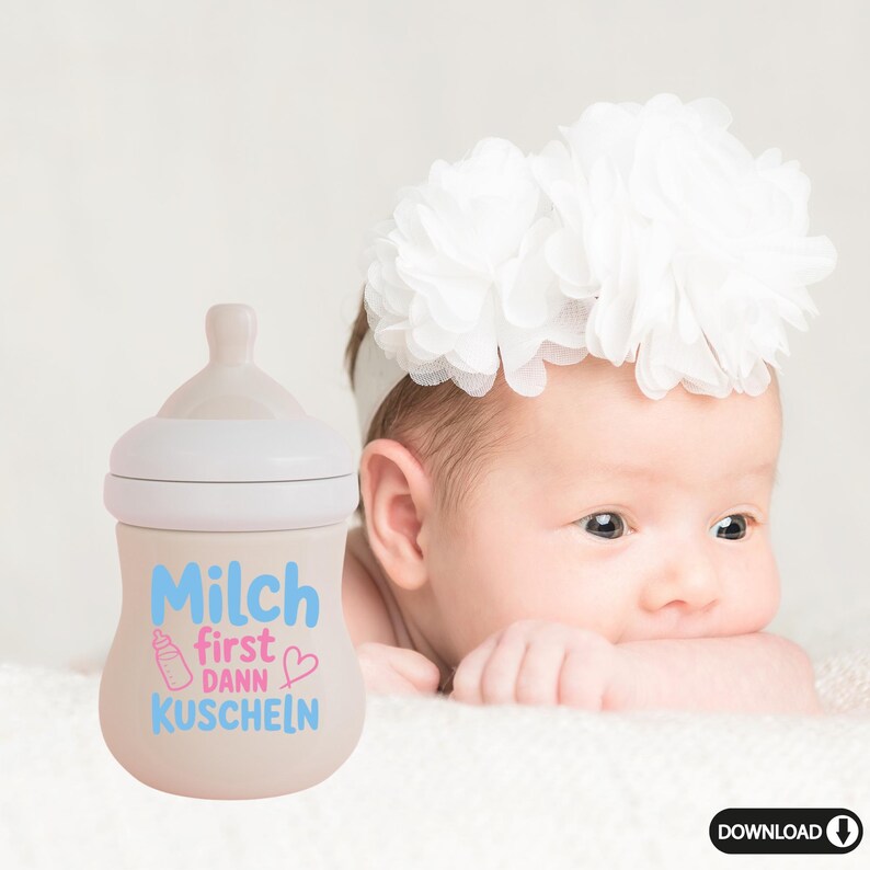 May include: A beige baby bottle with a white top and a light blue and pink design that reads "Milch first dann Kuscheln" with a baby bottle graphic and a heart. A baby wearing a white floral headband is in the background.