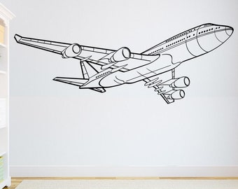 May include: Black and white line drawing of an aeroplane in flight. The aeroplane is facing to the right and has a long, narrow body with two wings and a tail.