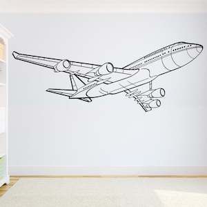 以下が含まれることがあります： 飛行中の飛行機の白黒線画。飛行機は右向きで、長く細い胴体と2つの翼と尾翼があります。