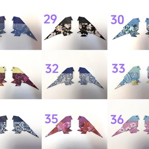 May include: A set of 9 pairs of origami birds, each pair is numbered 28-36. The birds are made from patterned paper and have blue, pink, purple, and yellow accents.