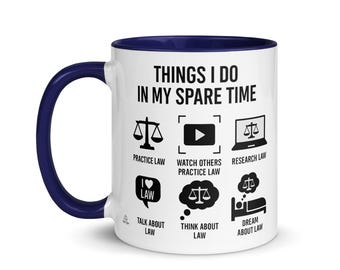 May include: White ceramic mug with a navy blue handle and interior. The mug features the text "THINGS I DO IN MY SPARE TIME" and icons representing law-related activities such as practicing, watching, and researching law.