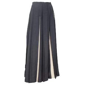 May include: A white ceramic mug with a black handle and the text "But First, Coffee" in a black, handwritten-style font. The mug is on a white surface.