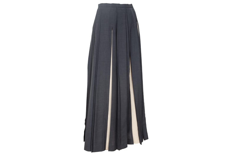 May include: A white ceramic mug with a black handle and the text "But First, Coffee" in a black, handwritten-style font. The mug is on a white surface.