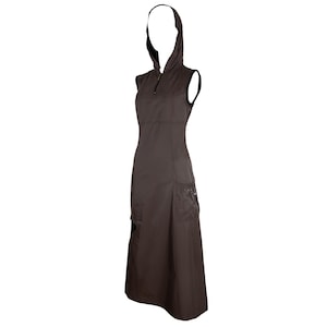 May include: A sleeveless, dark brown dress with a hood and a zipper closure. The dress features two pockets on the lower front and a fitted bodice. The dress is knee-length and made of a smooth fabric.