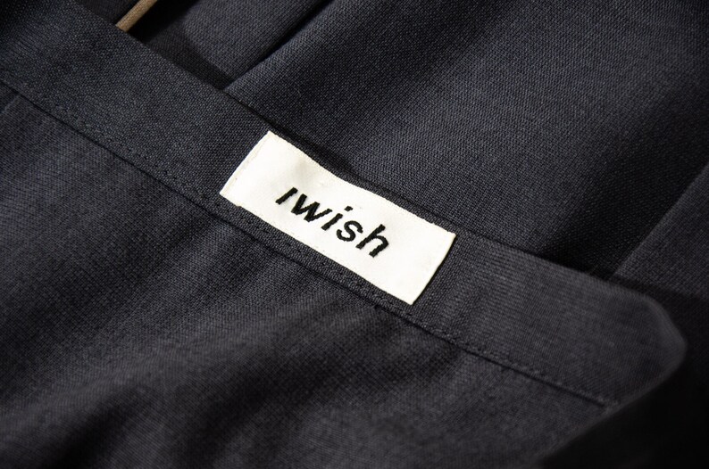 May include: A set of three ceramic mugs with a speckled, cream-colored glaze. Each mug features a different hand-painted floral design in shades of blue, green, and yellow. The mugs have a simple, modern shape.