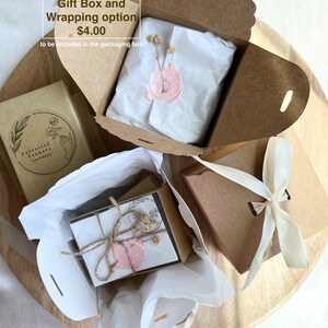 May include: A brown gift box with a white ribbon and a pink wax seal. The box is open and there is tissue paper inside. The text "Gift Box and Wrapping option $4.00 to be included in the packaging box" is visible on the box.