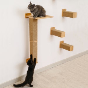 May include: Two cats playing on a wall-mounted cat tree. The cat tree has a scratching post and multiple platforms. One cat is gray and the other is black.