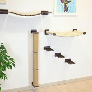 May include: A wall-mounted cat furniture set featuring a dark brown wooden suspension bridge, a vertical sisal-wrapped scratching post, a beige fabric hammock, and three small rectangular dark brown wooden steps mounted in a staggered pattern.