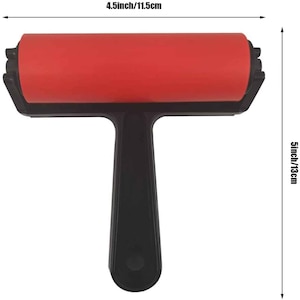 May include: A red and black paint roller with a handle. The roller is 11.5 cm long and 13 cm tall.