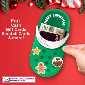 May include: A green Christmas stocking with a white border and the words "Merry Christmas" printed on it. The stocking is open at the top and has a £10 and £30 note inside. The stocking is decorated with a gingerbread man, a star, and a Christmas pudding. The text "DIY: CUT, GLUE, ASSEMBLE POSTED TO YOU" is printed on a white rectangle at the bottom of the image.