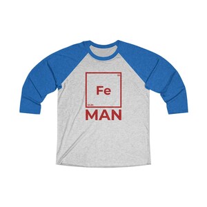 May include: A gray and blue baseball tee shirt with a red square graphic featuring the chemical symbol for iron, Fe, and the word "MAN" below it.