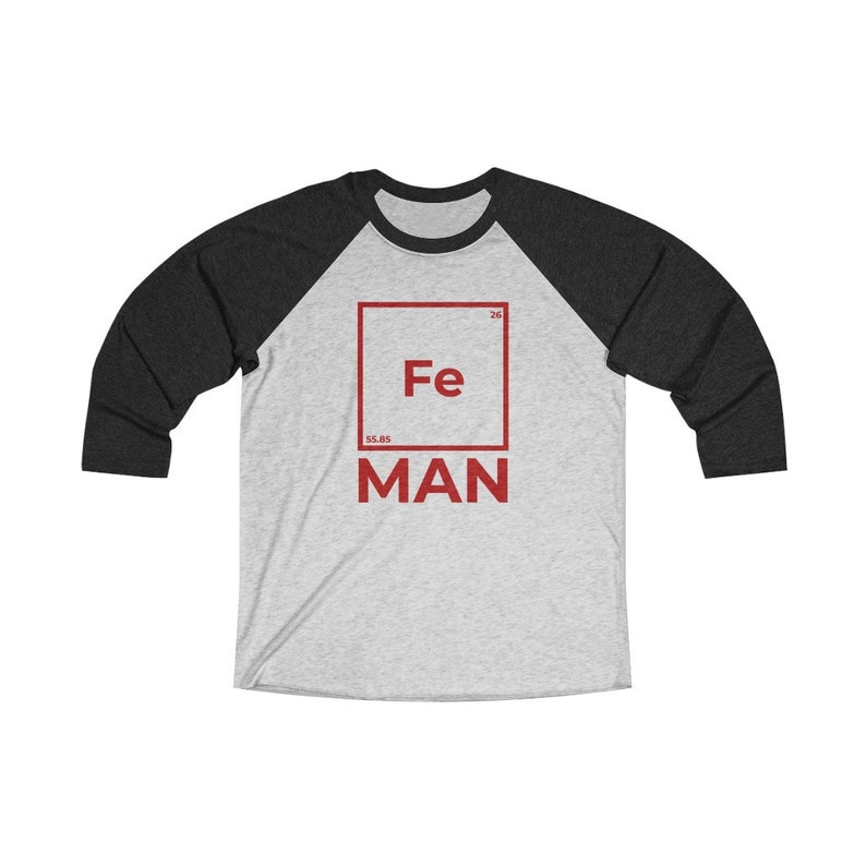 May include: A grey and black baseball tee shirt with a red square graphic featuring the chemical symbol for iron, Fe, and the word "MAN" below it.