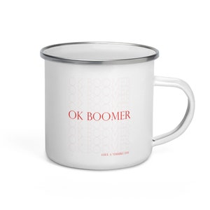 May include: White enamel mug with a silver rim and handle. The mug features the text "OK BOOMER" in red, with a faded pattern of the same text in the background. The phrase "HAVE A TERRIBLE DAY" is printed at the bottom.