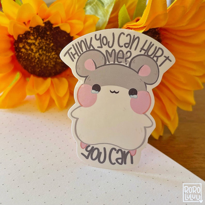 May include: A white sticker with a cartoon hamster with the text "Think you can hurt me? You can" in black.