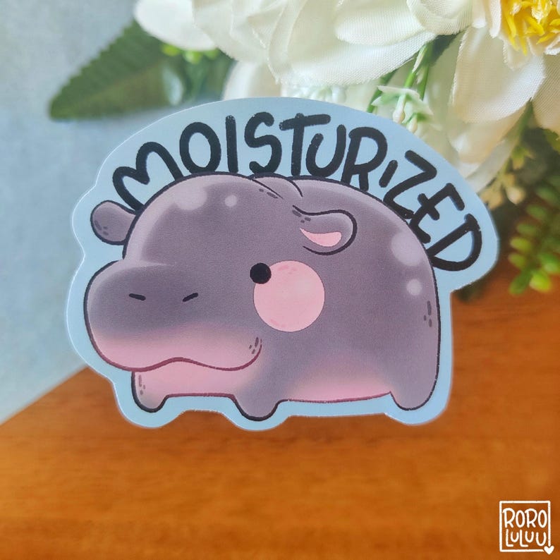May include: A blue sticker with a cartoon hippopotamus and the text "Moisturized" in black lettering.