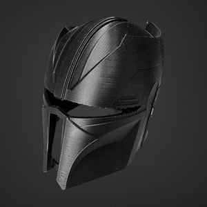 May include: A black helmet with a textured surface and a visor. The helmet has a futuristic design with a series of lines and ridges.
