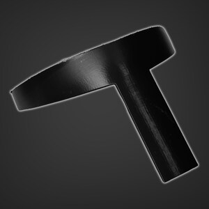 May include: A black plastic T-shaped object with a circular top. The object is designed to be used as a bottle stopper.