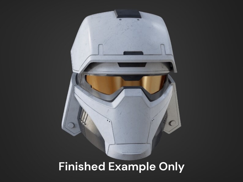May include: A white helmet with a black visor and a textured surface. The helmet has a gold-colored visor and a black trim around the edges.