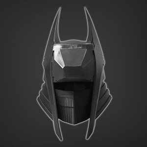 Puede incluir: Un casco negro con un dise&ntilde;o puntiagudo y angular. El casco tiene una visera grande y puntiaguda y una serie de crestas en los lados.